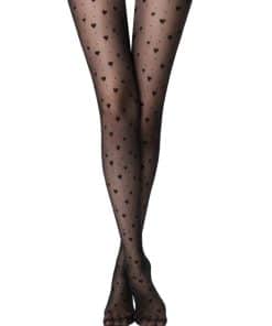 Legs wearing sheer black tights with small heart motifs, ankles crossed.