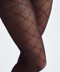 Close-up of legs in sheer black tights with a red stitched dot-and-line pattern.