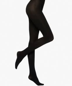 Black opaque tights on legs, one leg crossed over the other against a white background.