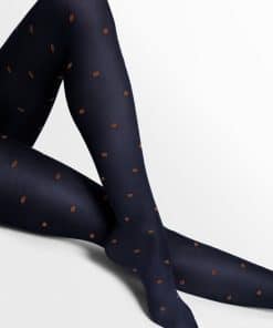 Navy polka-dot tights worn on legs, crossed at the knee, against a white background.